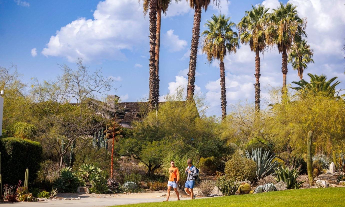 Students walk to class in front of the Grove House